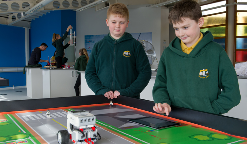 Two children looking at a digital experiment at the Science skills academy